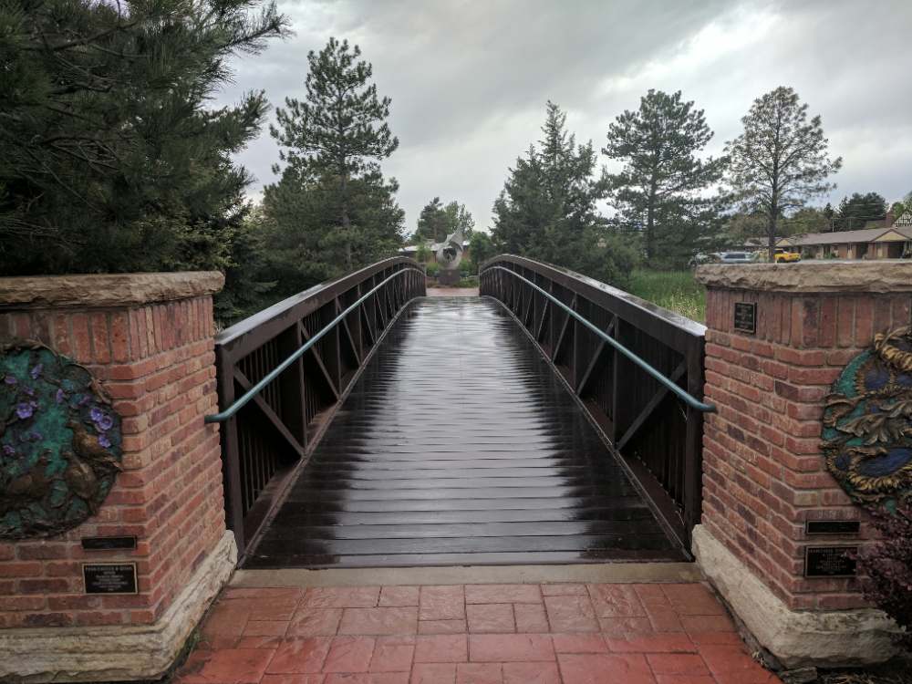 A footbridge over the stream at Benson Sculpture Garden in Loveland, Colorado